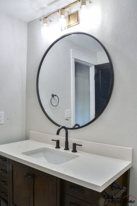 Flip House Reveal Featuring Kichler, Bathroom Light Fixtures Over Round Mirror